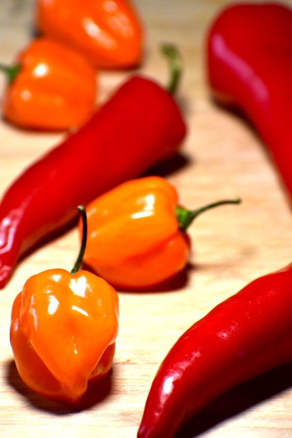 some hot peppers on a cutting board