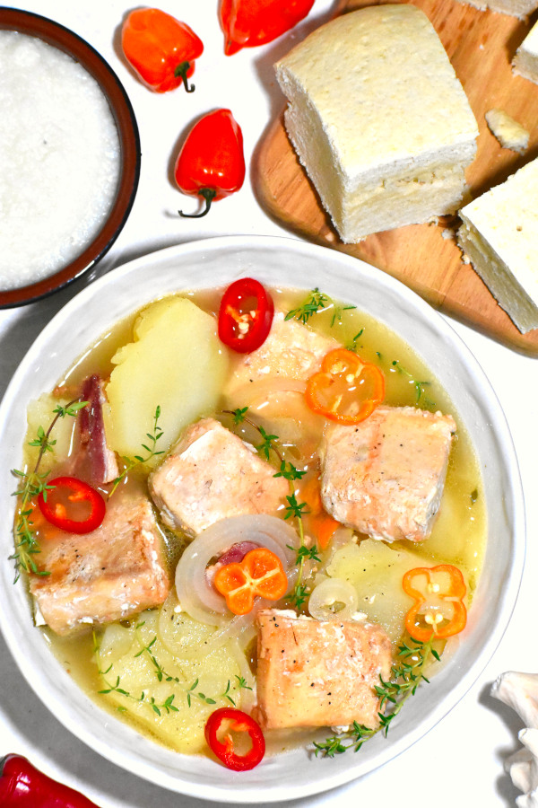 boiled fish alongside johnny cake and grits